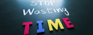 Stop wasting time concept, colorful words on blackboard